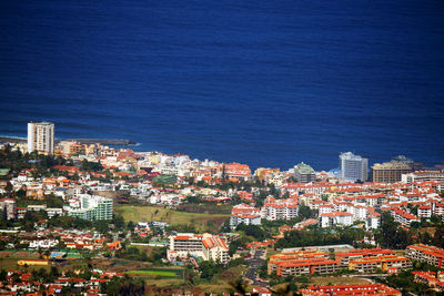 High angle shot of townscape against blue sea