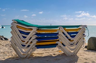 Stack of lounge chairs on beach
