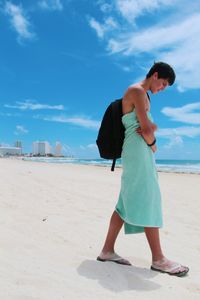 Full length of woman standing at beach