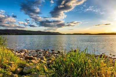 Scenic view of lake against sky during sunset