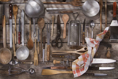 Various kitchen utensils hanging on wood