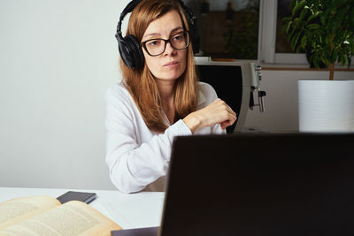 Online course, distance education and e-learning concept. woman in headphones listen audio course