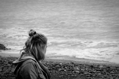 Close-up of woman standing at sea shore