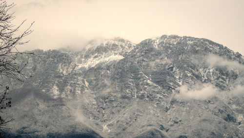 Close-up of snow covered mountains against sky