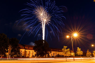 Low angle view of firework display at night