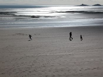 People on beach against sky