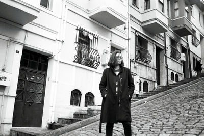 Man standing by building in city