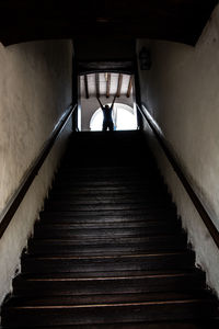 Rear view of woman on staircase in building