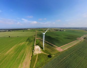 Aerial drone photo of a wind turbine close up in green field