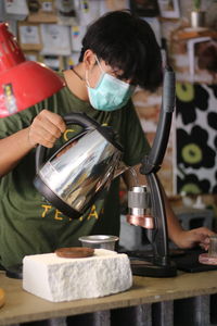 Rear view of woman preparing food in kitchen