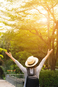 Rear view of person standing by plants