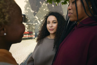 Portrait of woman standing with female friends