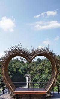 Trees by plants against sky