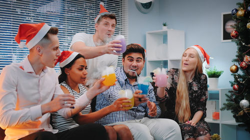 Portrait of smiling friends enjoying at home