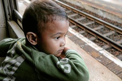 Boy looking through window in train