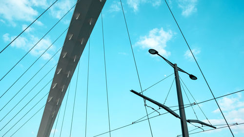 Low angle view of cables against blue sky