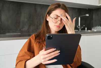 Young woman using digital tablet