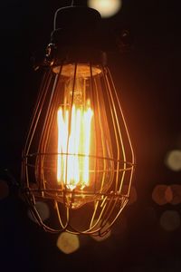 Close-up of illuminated light bulb at night
