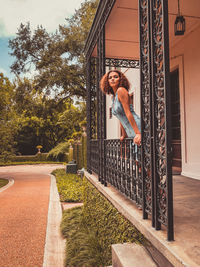 Portrait of smiling woman against built structure