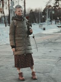 Full length of woman standing on snow