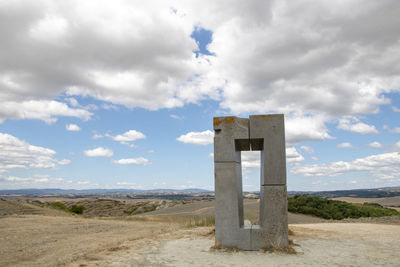 Built structure on field against sky