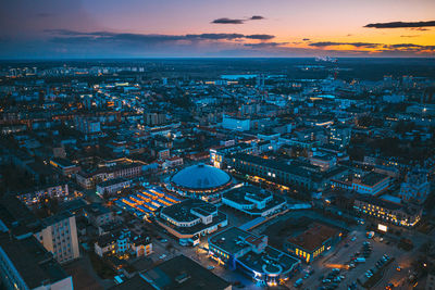 High angle view of illuminated city buildings at sunset