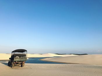 Scenic view of desert against clear blue sky