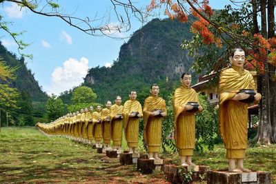 Statue of buddha against trees