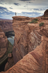 Man photographing horseshoe bend point at sunset