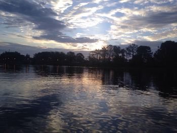 Scenic view of lake against sky at sunset