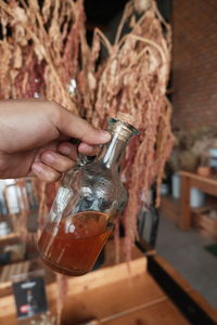 Close-up of person holding glass