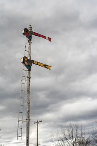 Low angle view of crane against sky