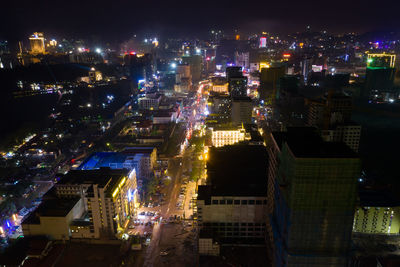 High angle view of illuminated buildings in city at night