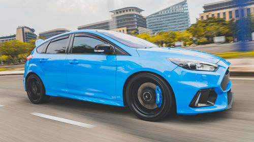 View of blue car on road