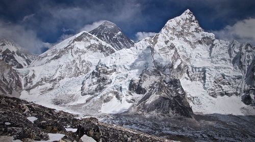 Low angle view of snowcapped mountains against sky