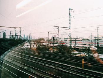 Railroad tracks seen through glass window with reflection