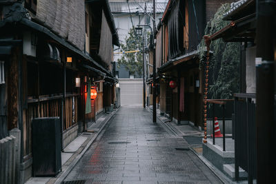 Empty street amidst buildings in city