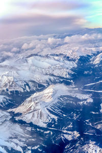 Aerial view of snowcapped mountains against sky