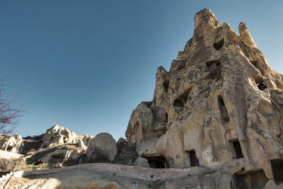 Low angle view of rock formation against clear sky