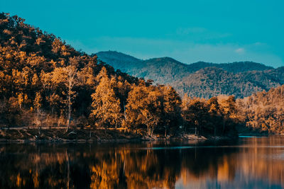 Scenic view of lake by trees against sky during autumn