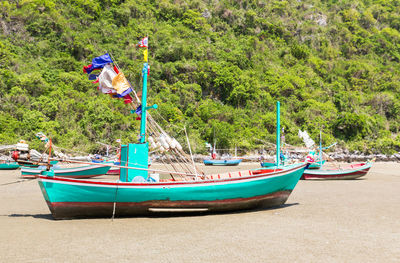 Boats moored on sea shore