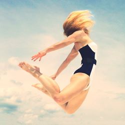 Low angle view of woman standing against sky