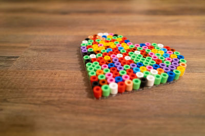 High angle view of multi colored candies on wooden table
