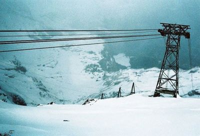 Scenic view of snow covered mountain against cloudy sky