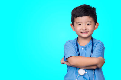 Portrait of boy against blue background