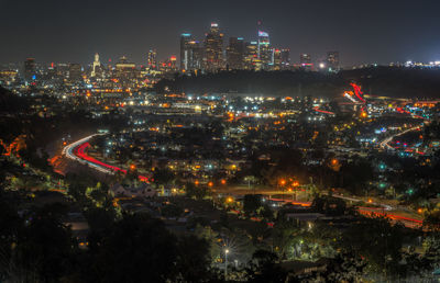 High angle view of illuminated buildings in city at night