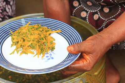 Midsection of woman holding food