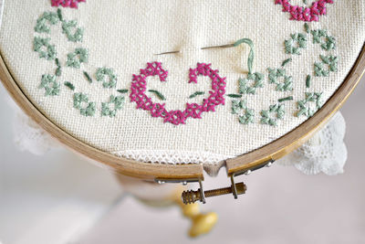 High angle view of rose on table against white background
