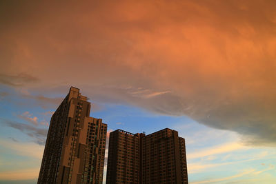 Low angle view of buildings against sky during sunset