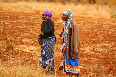 Farm workers standing on agricultural field